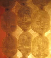 View larger version of a close up of Dee Shaw's Cabinet 2, close up of masks.